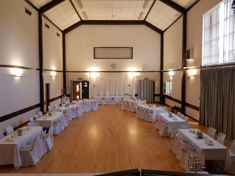 Dorothy Hatswell Hall set with tables and chairs for a celebration